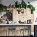 kitchen with black wire metal bar stools and hanging glass vases