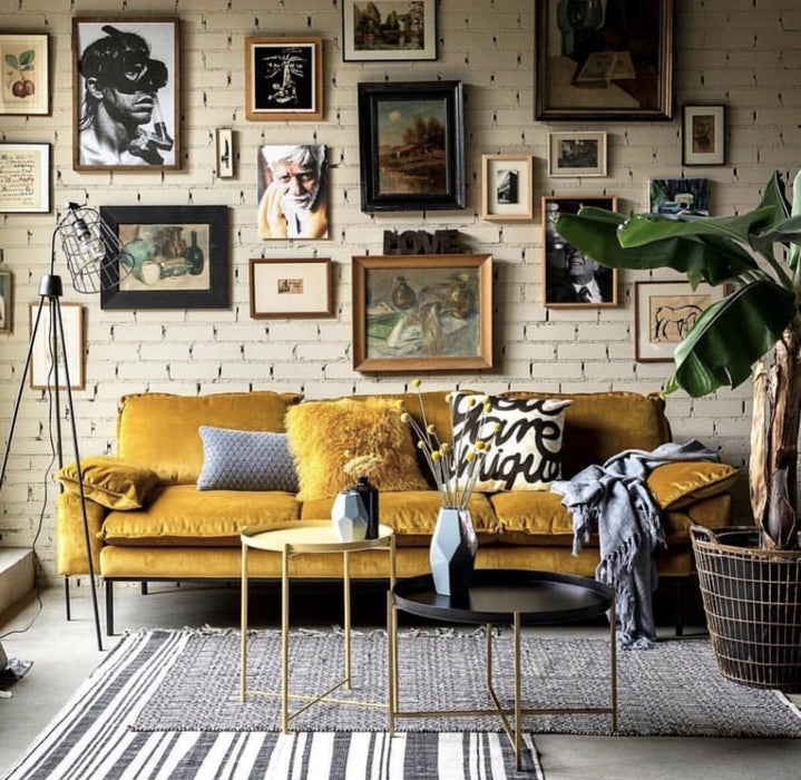 velvet ochre sofa with you are unique pillow and gallery wall