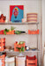 pantry with painting, orange crates and dinnerware