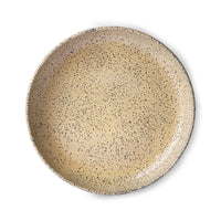 peach colored round deep plate made from speckled stoneware