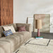 beige sectional sofa with modern pillows and abstract painting