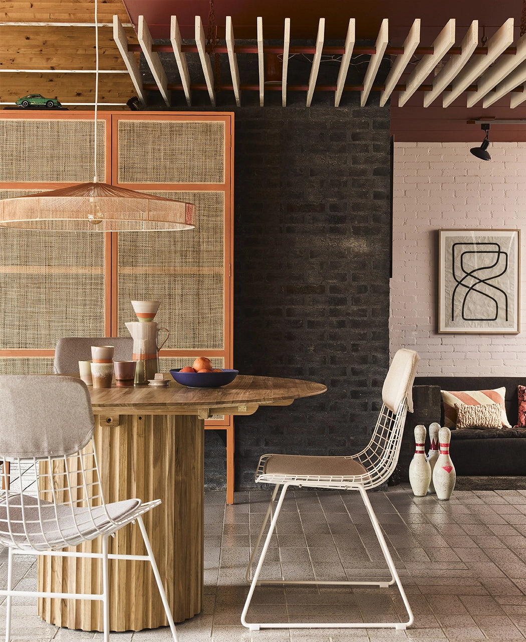 retro style dining room with teal wooden table and white metal dining chairs 