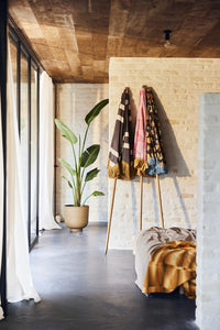 3 parasols with different fabric against a wall