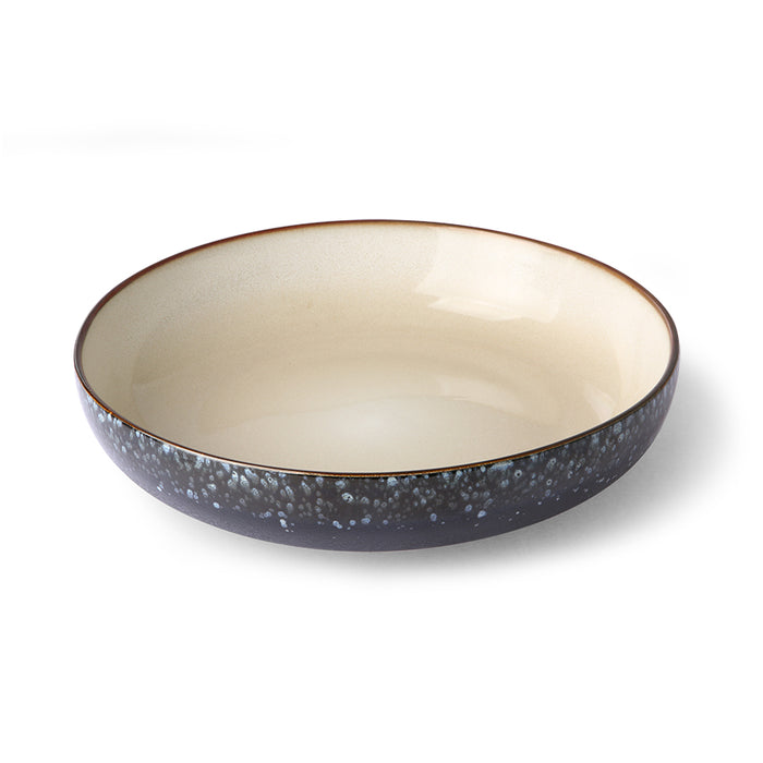 large, handmade black serving bowl with cream colored inside