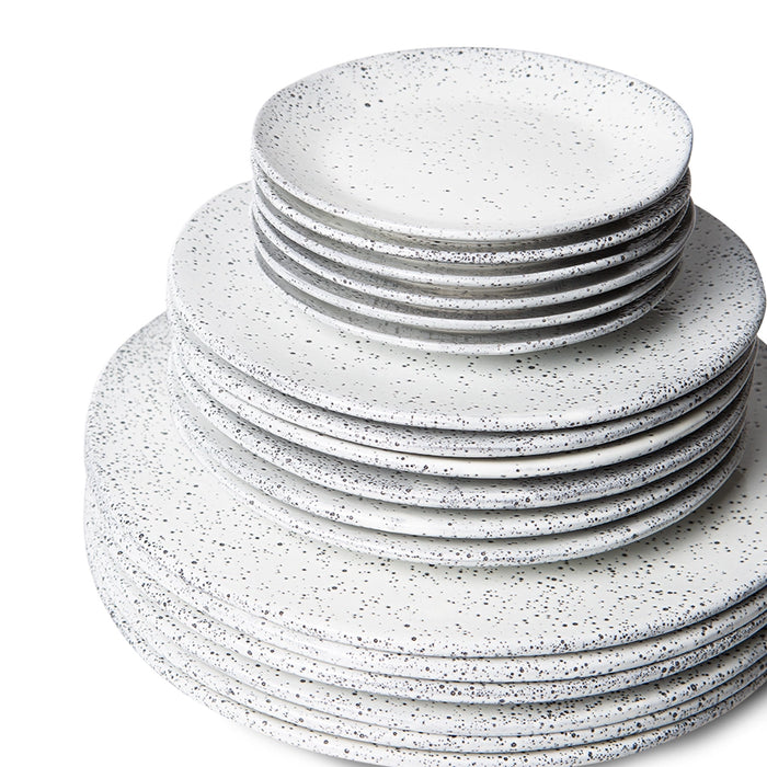 stack of white side plates with dark speckles