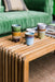 teak wooden slatted coffee table with green, orange, blue and cream colored stoneware retro style coffee cups