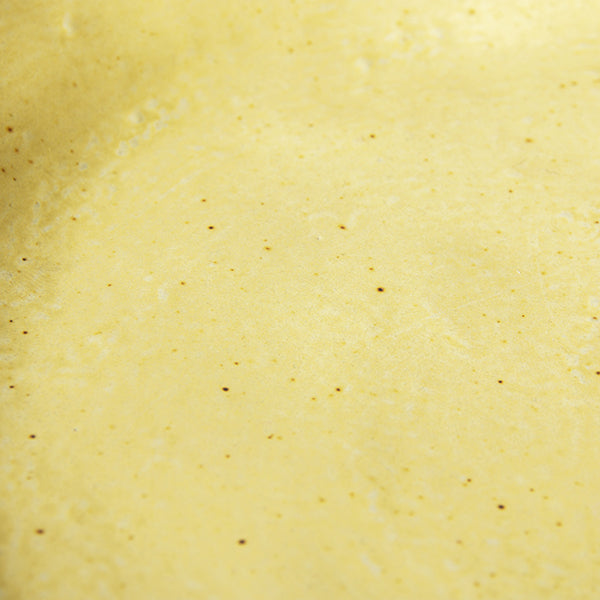 detail of organic shaped side plates in yellow with brown accents