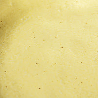 detail of organic shaped side plates in yellow with brown accents