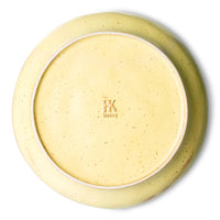 back of deep porcelain plate yellow and brown color
