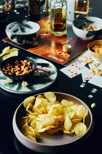 table with snacks and assorted nuts in an organic shaped black bowl