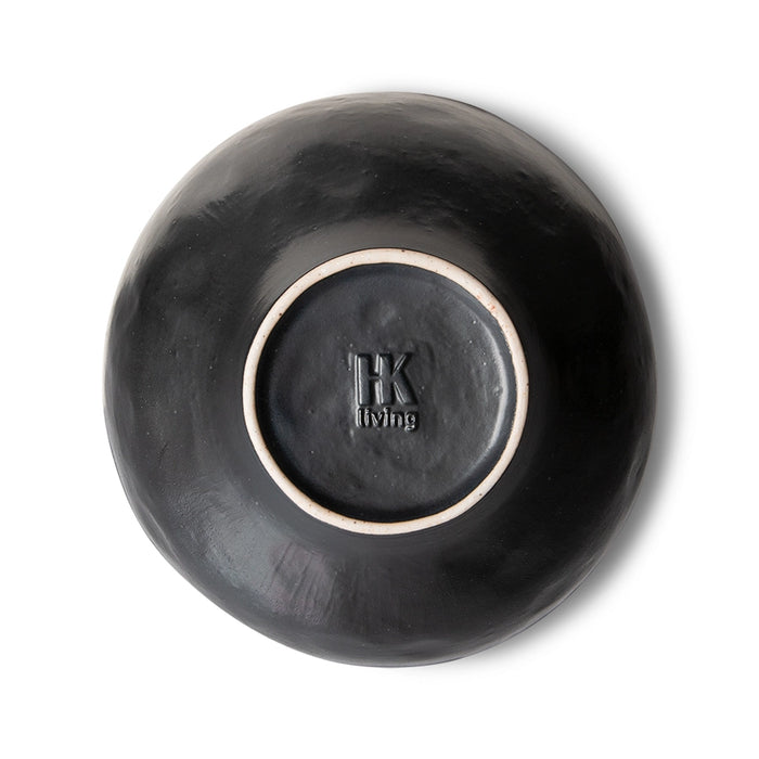 bottom of an organic shaped black porcelain bowl
