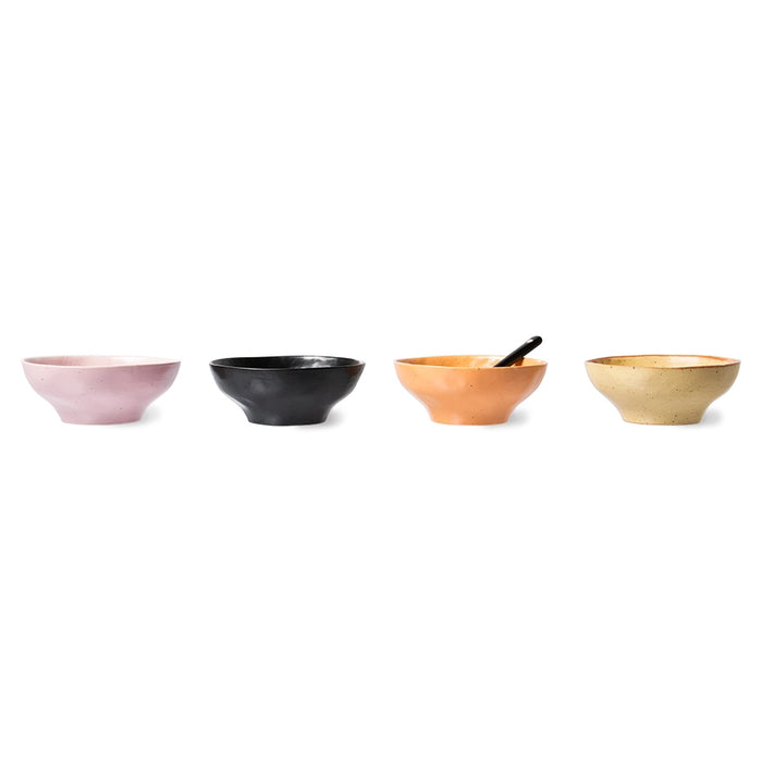 pink, black, orange and yellow bowls made from organic shaped porcelain next to each other