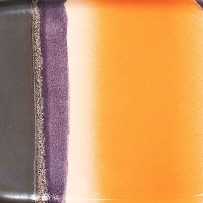 detail of reactive glaze finish of small stoneware tray in orange and purple