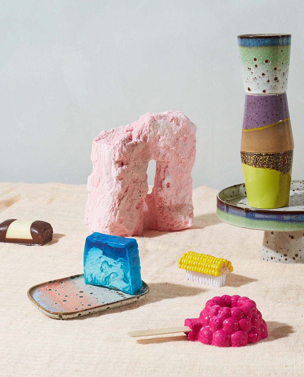 small stoneware tray with blue soap bar and a stack of tumbler mugs