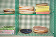 rustic brown and cream deep porcelain plate  in a green open shelving rack