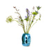 small shiny blue chrome flower vase object with flowers