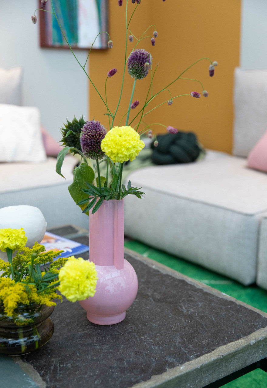glass flower vase in flamingo pink with flowers