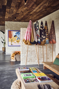 6 parasols with different fabric against a wall  
