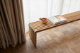 reclaimed teak wooden slatted bench with books and bowl