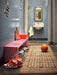 hallway with grey walls and slatted bench in hot pink