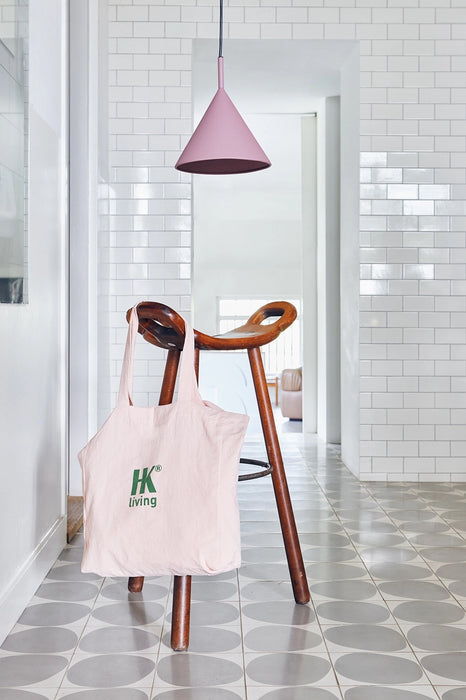 pink tote in a kitchen setting with a cherry colored  single pendant light