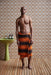 brown and orange striped large towel with fringes wrapped around a mans torso