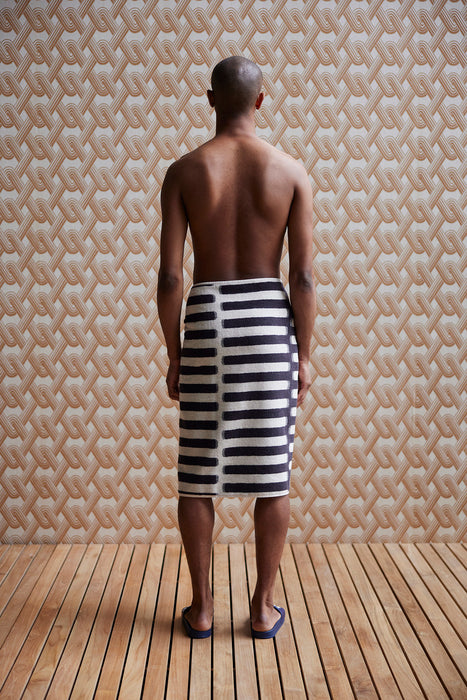 striped towel wrapped around a man