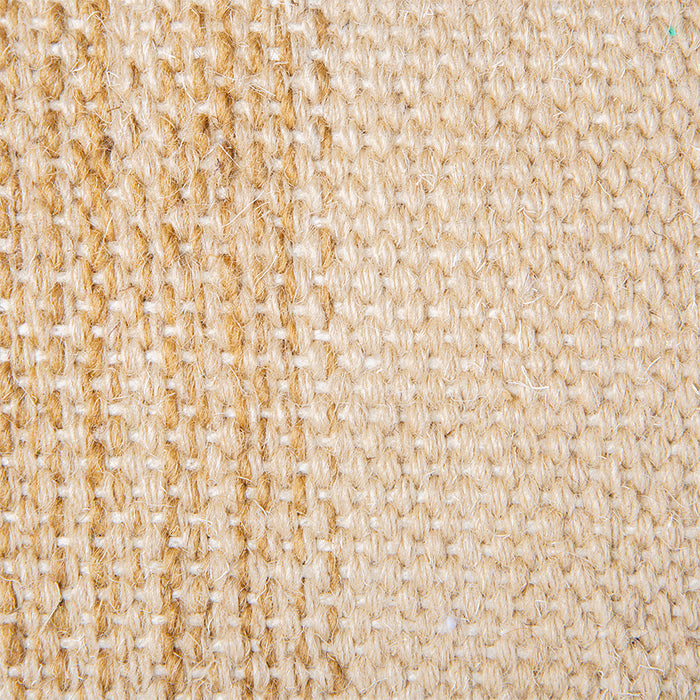 detail of large handwoven woolen lumbar pillow in neutrals with white piping