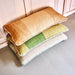 3 large hand woven woolen lumbar pillows stacked together
