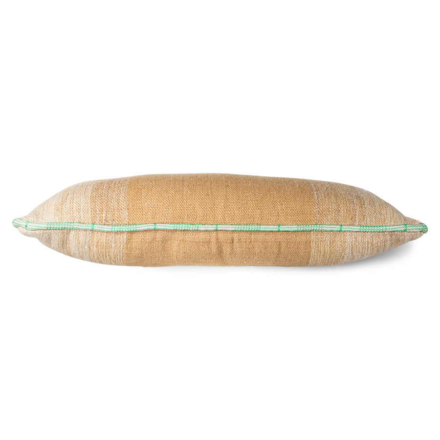large hand woven wool lumbar pillow in camel and cream with a white and green piping