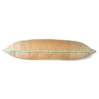 large hand woven wool lumbar pillow in camel and cream with a white and green piping