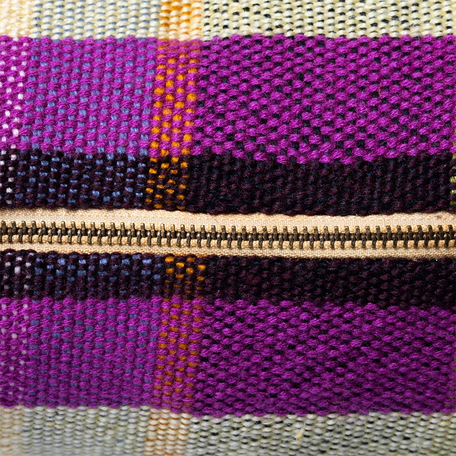 detail of zipper of multicolored cotton retro style throw pillow 