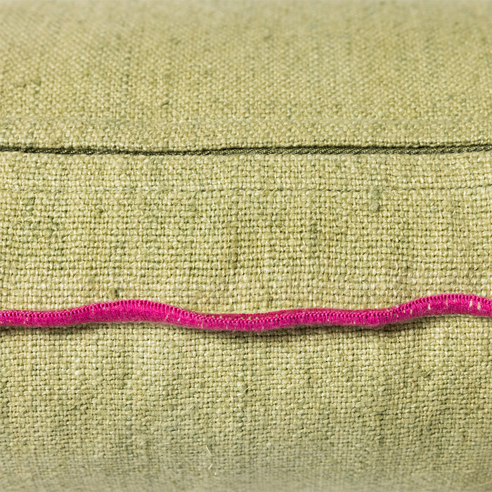 detail of green linen lumbar pillow with pink cotton trim