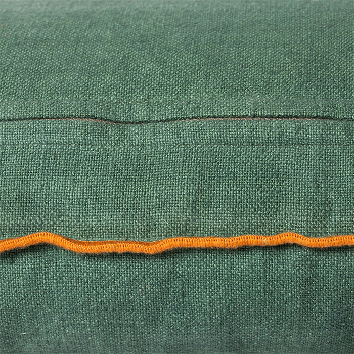 detail of green linen lumbar pillow with ginger orange trim