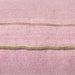 detail of pink linen lumbar shaped pillow with green cotton trim