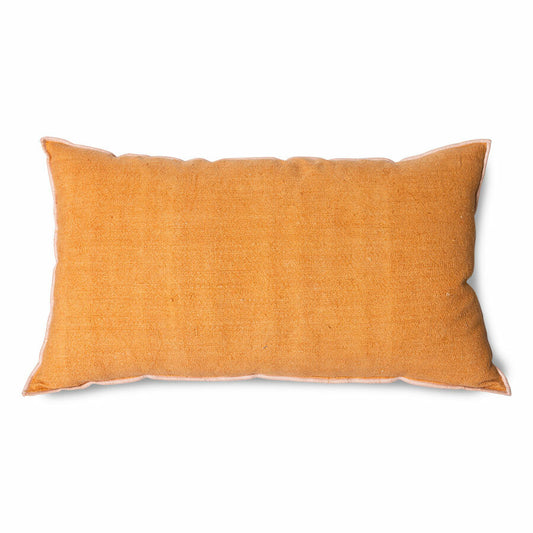 lumbar shape orange linen pillow with a blush colored cotton trim