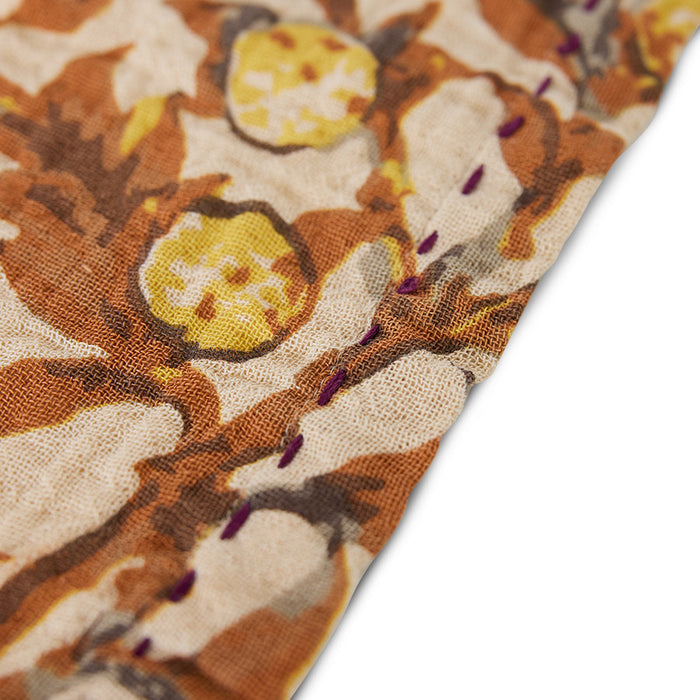 detail of cotton napkin with purple stitches