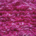 close up of a hand knotted pink woolen rug
