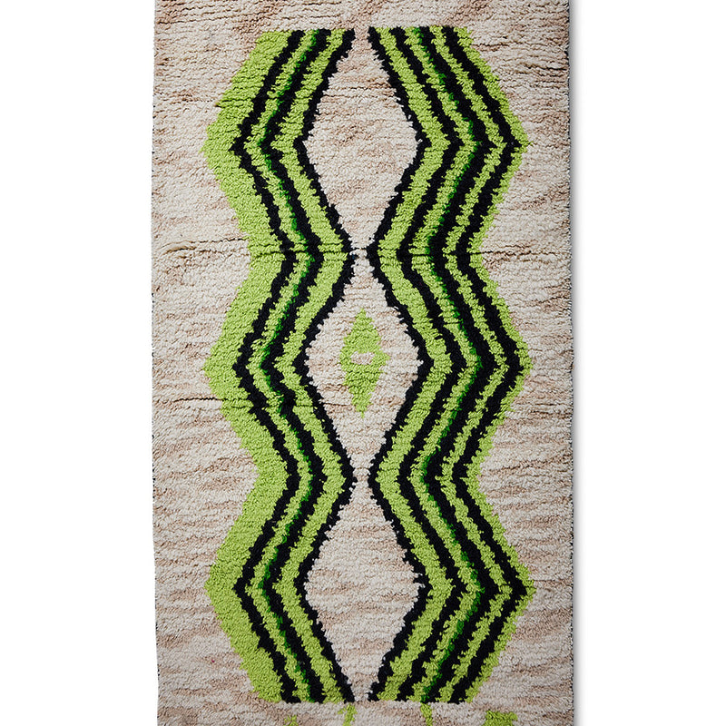 detail of long runner made from hand knotted natural wool with neon green and black pattern