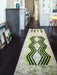 long runner made from hand knotted natural wool with neon green and black pattern in a living room with fire place and black wooden floor