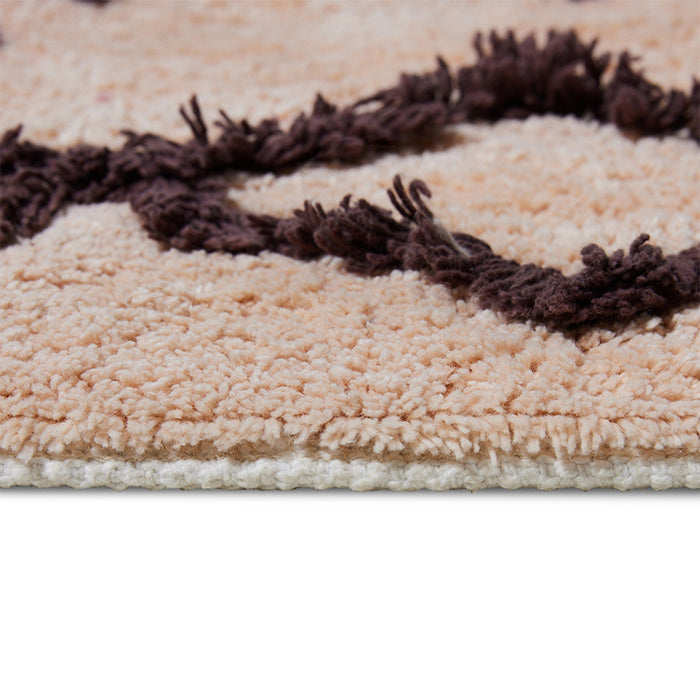 detail of large cotton bohemian style bat rug with purple hues