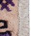 detail of large cotton bohemian style bat rug with purple hues