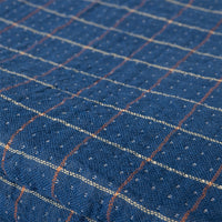 detail of blue fabric with red and orange details from Sherpa throw blanket