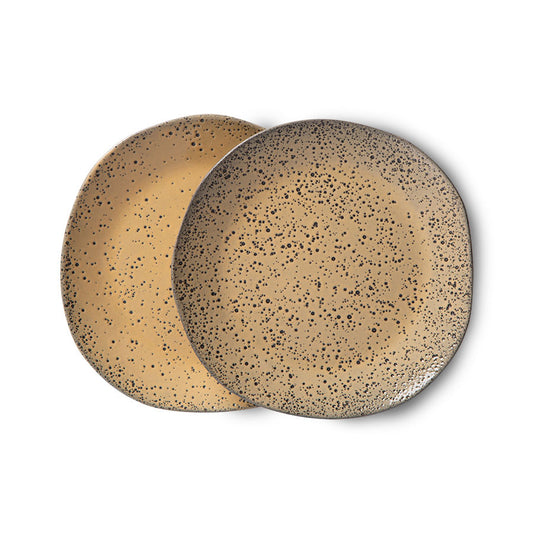 two appetizer plates made from stoneware with a speckled surface