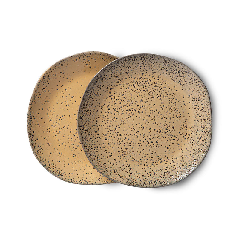 two appetizer plates made from stoneware with a speckled surface
