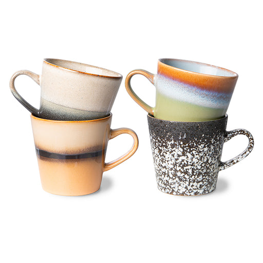 multi colored coffee mugs with an ear made from stoneware in orange, green, brown and cream