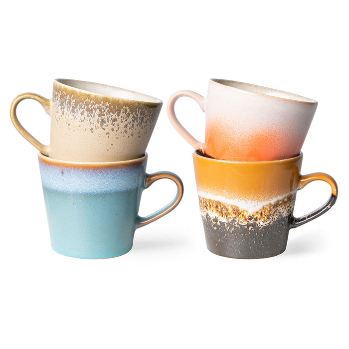 4 colorful mugs with an ear made from stoneware in blue, orange cream and white