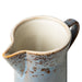 detail of cream and blue color stoneware creamer