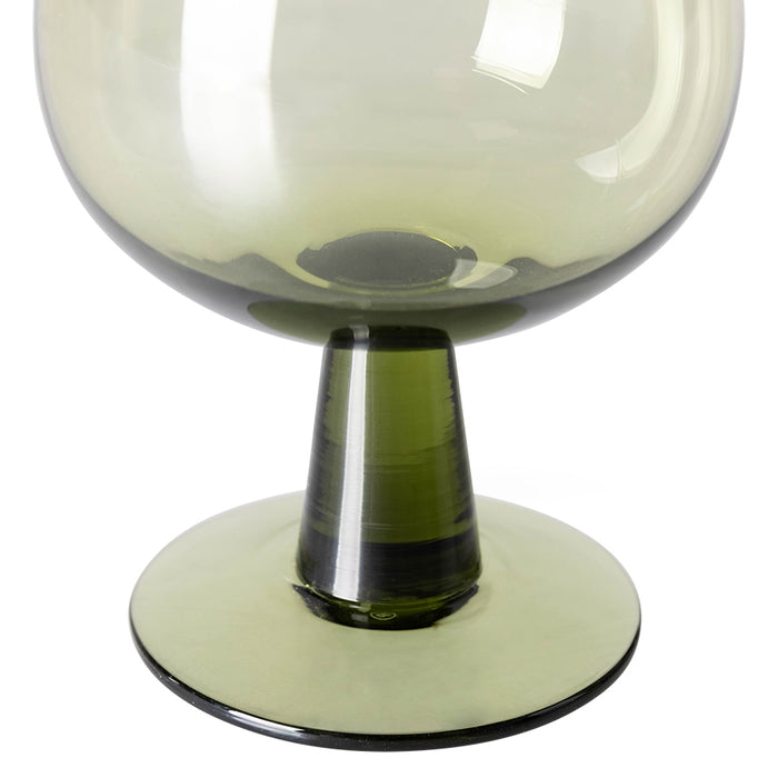 detail of olive green wine glass on low stem