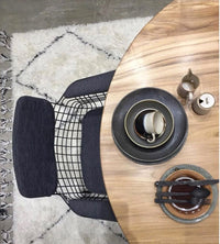teak wooden round table and black metal arm rest chair with charcoal comfort kit